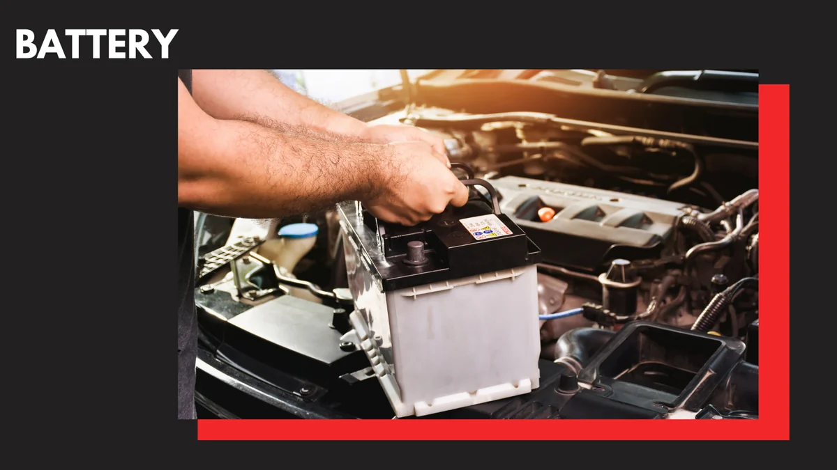 An automotive mechanic installing a new battery.