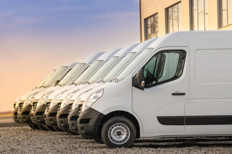 White commercial vans lined up in row